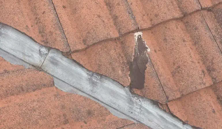 Securing slipped valley tiles with silicone